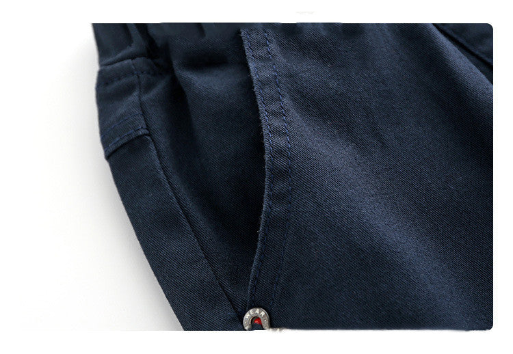 Close-up of a navy blue fabric with a button on a white background