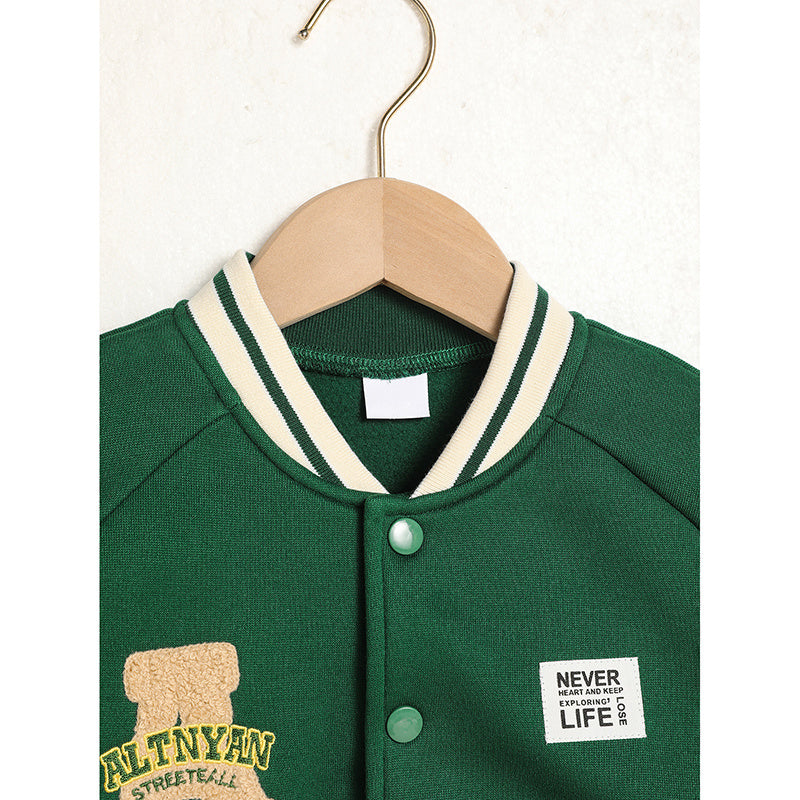 Green varsity jacket with white trim on a wooden hanger against a white background