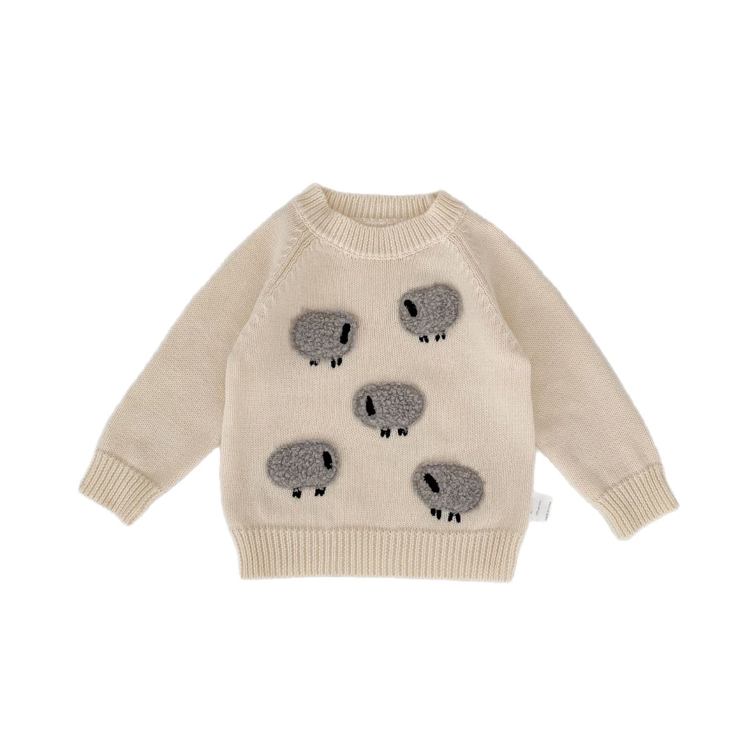 Beige sweater with koala designs on a white background