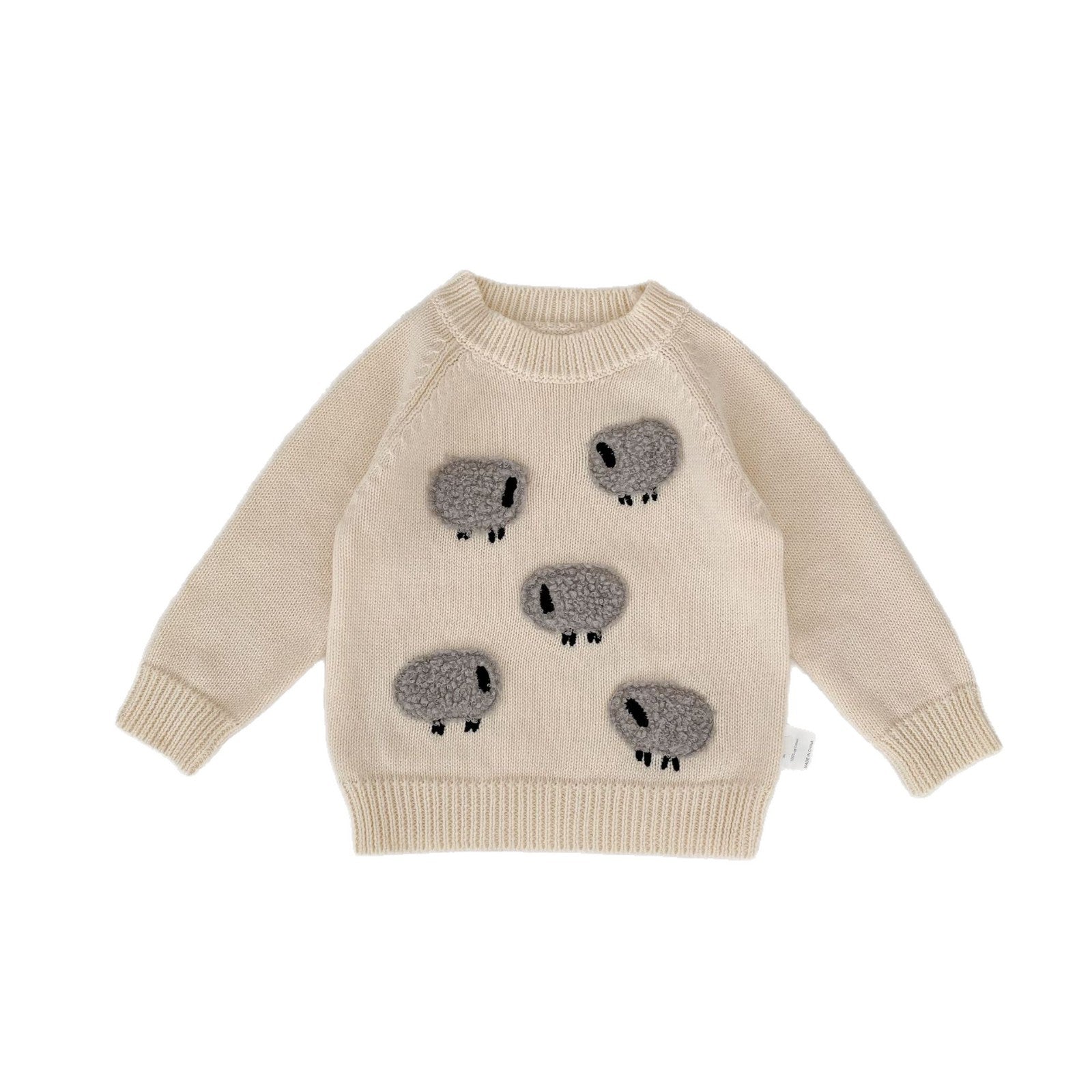Beige sweater with koala designs on a white background
